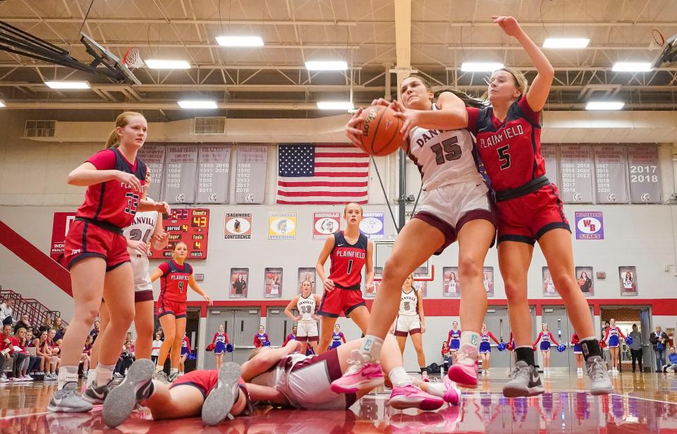 Danville's forward Ava Walls (15) recovers a rebound against Plainfield Quakers guard Morgan Barnes (5) on Saturday, Jan. 6, 2024, during the game at Danville Community High School in Danville.