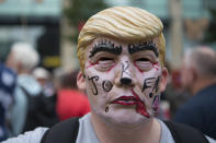 <p>A man wears a Donald Trump mask as protesters gather outside Cardiff Library on the Hayes in Cardiff to protest against a visit by the President of the United States Donald Trump on July 12, 2018 in Cardiff, United Kingdom. (Photo: Matthew Horwood/Getty Images) </p>