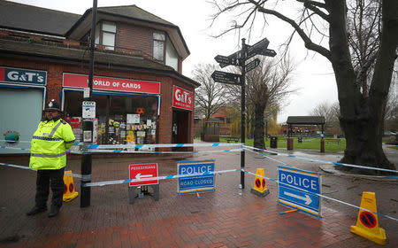 A police officer guards a cordoned off area in the city centre where former Russian intelligence officer Sergei Skripal and his daughter Yulia were found poisoned, in Salisbury, Britain, April 3, 2018. REUTERS/Hannah McKay