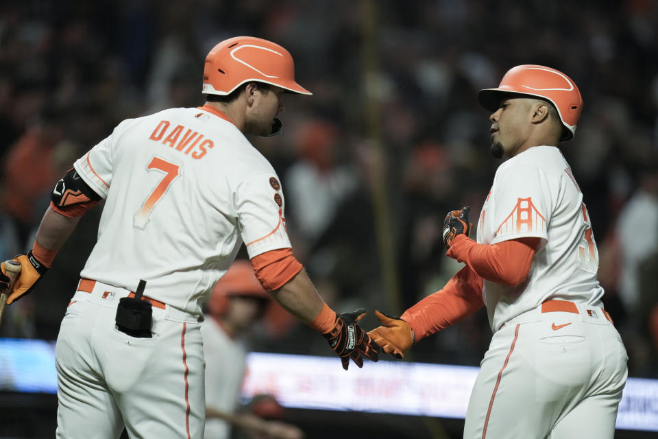 San Francisco Giants' LaMonte Wade Jr., right, celebrates with J.D. Davis after hitting a solo home run against the Arizona Diamondbacks during the seventh inning of a baseball game Tuesday, Aug. 1, 2023, in San Francisco. (AP Photo/Godofredo A. Vásquez)