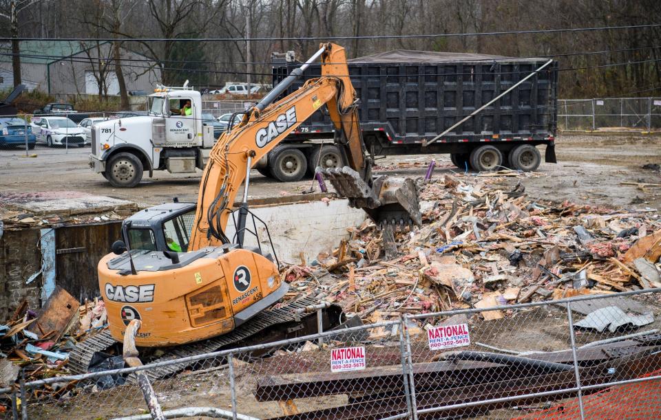 Rubble is scooped up Friday, Dec. 10, after the former Night Moves building on South Walnut Street was demolished to make way for an apartment complex.