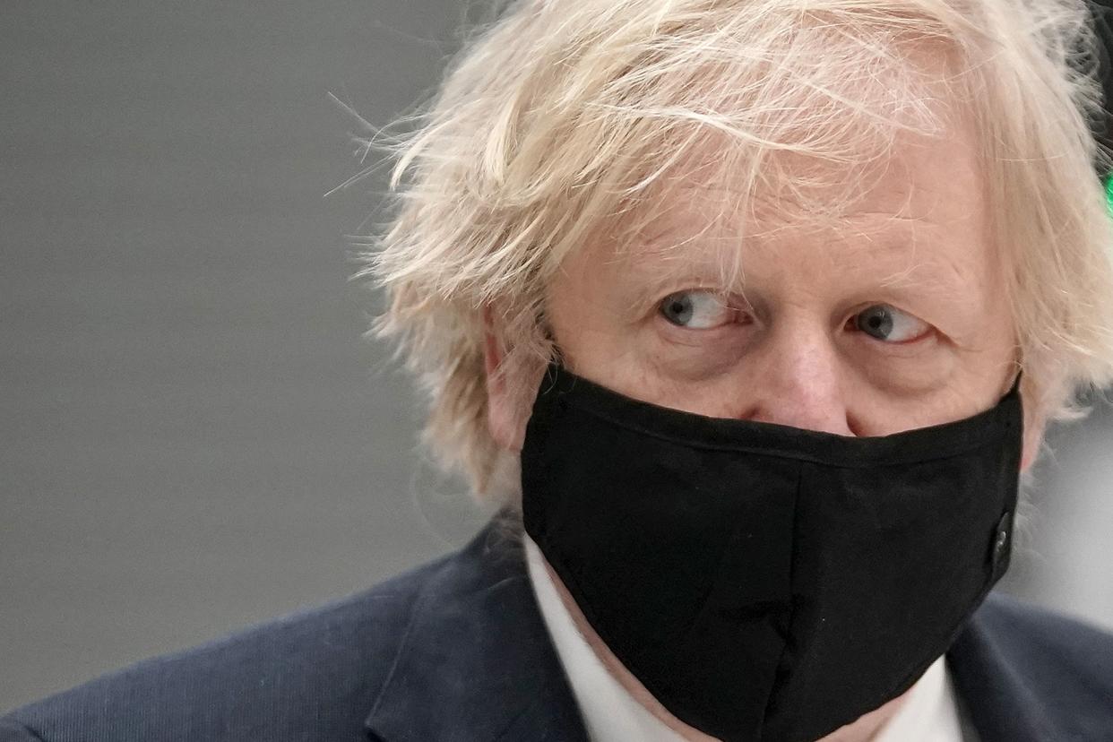 Britain's prime minister Boris Johnson wearing a mask because of the coronavirus pandemic visits BAE Systems at Warton Aerodrome in Preston, northwest England, on March 22, 2021. - The prime minister's visit comes to mark the publication of the UK government's Integrated Review, an overhaul of Britain's security, defence and foreign policy, billed as the biggest since the Cold War era. (Photo by Christopher Furlong / POOL / AFP) (Photo by CHRISTOPHER FURLONG/POOL/AFP via Getty Images)