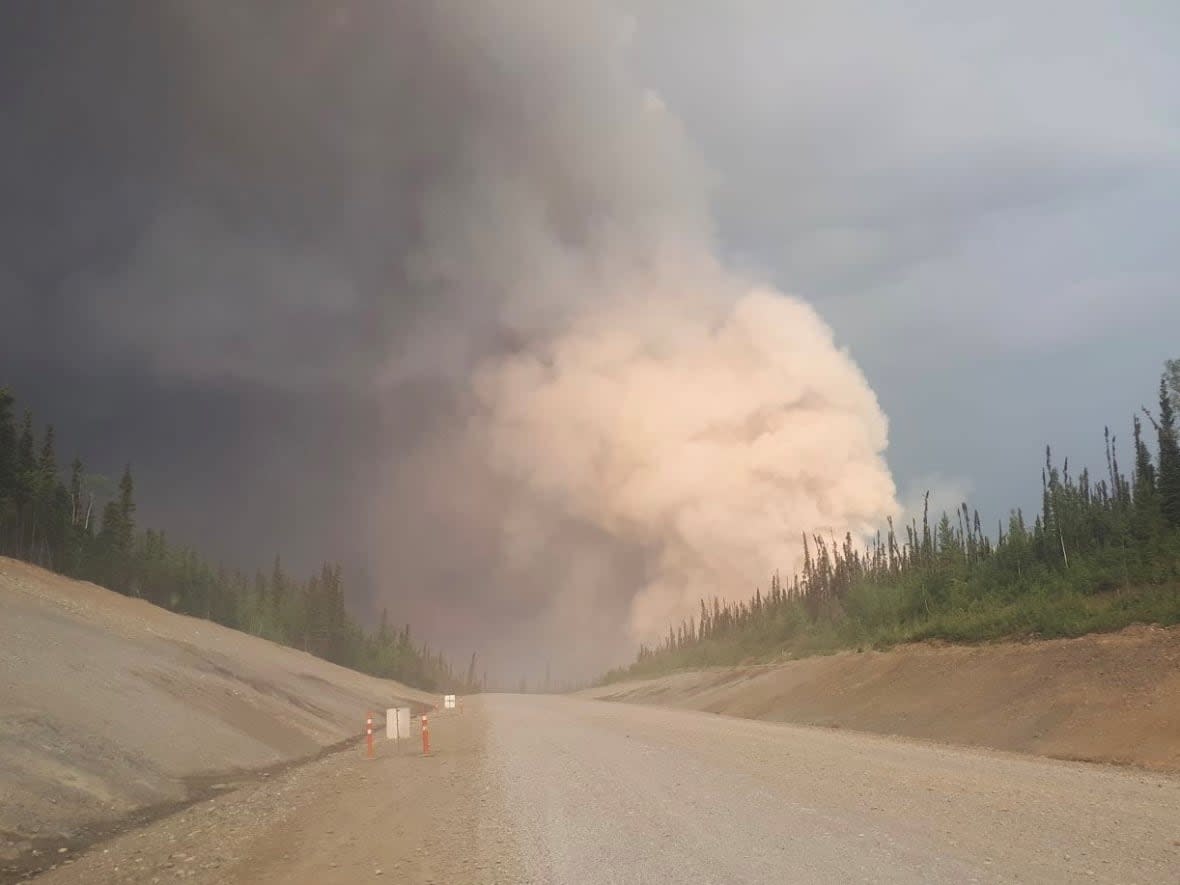 A photo of the Crystal Creek fire taken by a driver on the Klondike Highway. The Yukon Protective Services said the highway remains open right now, but urge drivers to monitor Yukon 511 for updates on the situation.  (Yukon Protective Services/ Facebook - image credit)