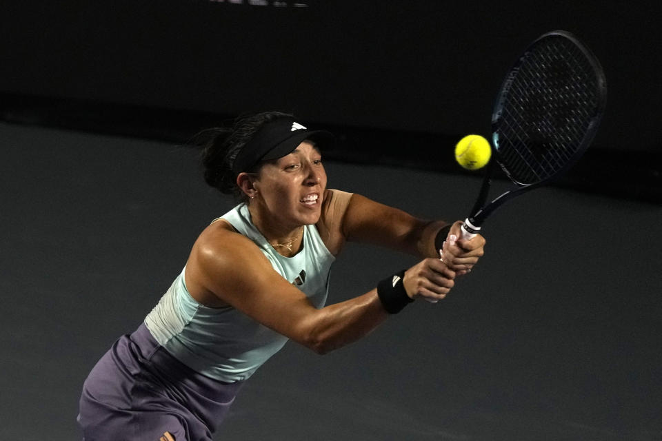 Jessica Pegula, of the United States, returns a shot to Coco Gauff of the United States, during a women's singles semifinal match at the WTA Finals tennis championships, in Cancun, Mexico, Saturday, Nov. 4, 2023. (AP Photo/Fernando Llano)