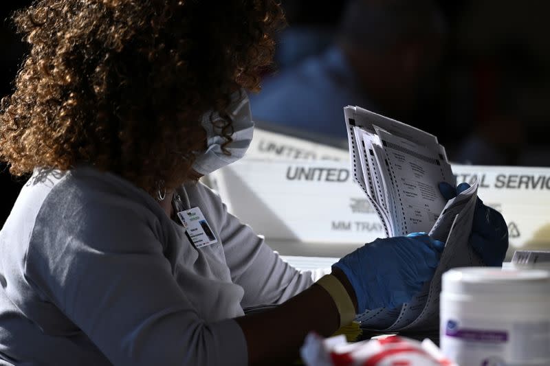 Employees of the Fulton County Board of Registration and Elections process ballots in Atlanta