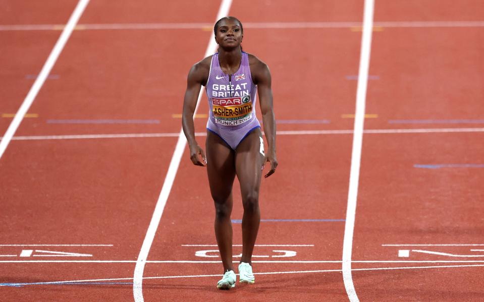 Dina Asher-Smith walks over the line after cramp, caused by her period, ruined her tilt for the 100m title - GETTY IMAGES