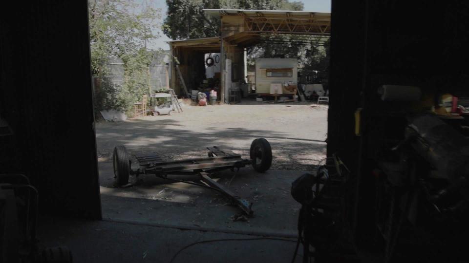 The view from inside Ray Wright's former Rio Linda workshop looking towards the trailer where Katie Barnard was staying. / Credit: CBS News