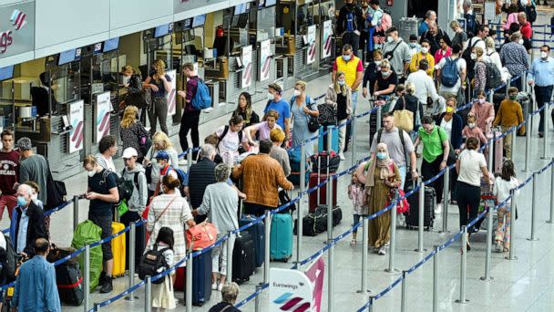 PHOTO: Passengers queue at the check-in counter of airline Eurowings, a subsidiary of the Lufthansa Group, at Duesseldorf International Airport (DUS), western Germany, on July 1, 2022. (Ina Fassbender/AFP via Getty Images)