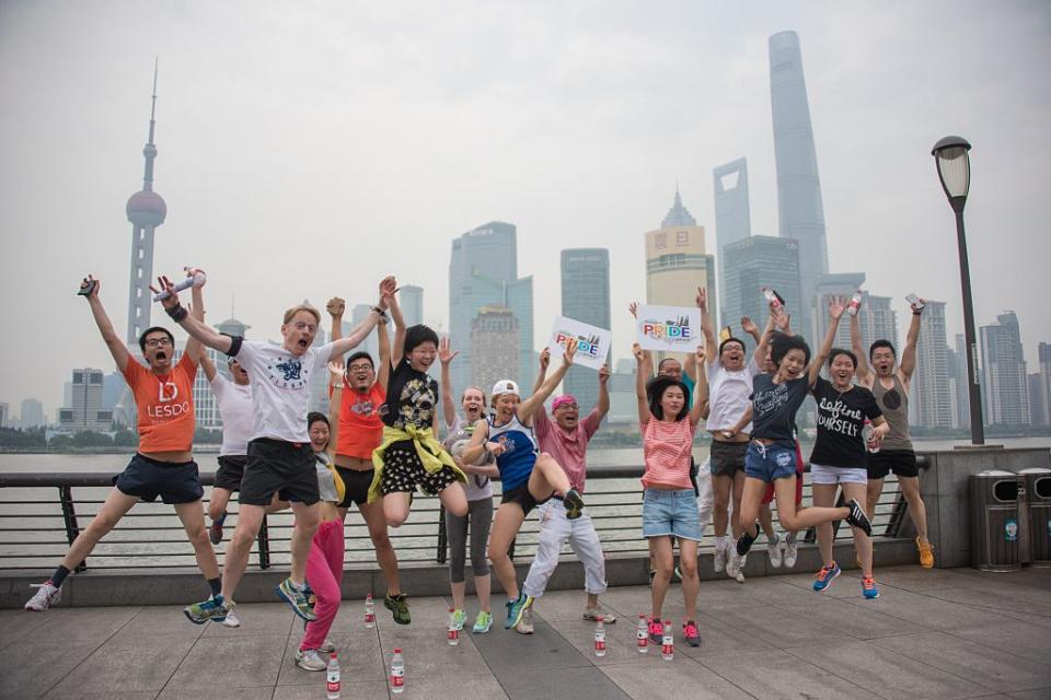 Participants of the ShanghaiPRIDE run pose for pictures during a break on the Bund in front of the financial district of Pudong in Shanghai on June 13, 2015.<span class="copyright">JOHANNES EISELE/AFP via Getty Images</span>