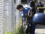 Family members of victims wait outside of a post office after a shooting, Tuesday, Oct. 12, 2021 in the Orange Mound neighborhood of Memphis, Tenn. Police investigated a shooting Tuesday at a post office in an historic neighborhood of Memphis, Tennessee, the third high-profile shooting in the region in weeks.(Patrick Lantrip/Daily Memphian via AP)