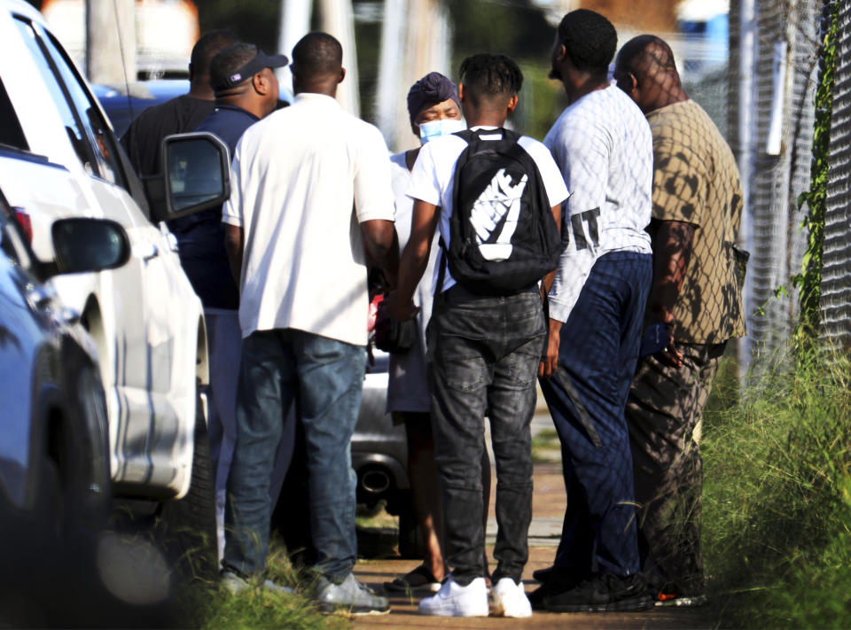 Family members of victims and employees pray outside of a post office after a shooting, Tuesday, Oct. 12, 2021 in the Orange Mound neighborhood of Memphis, Tenn. Police investigated a shooting Tuesday at a post office in an historic neighborhood of Memphis, Tennessee, the third high-profile shooting in the region in weeks.(Patrick Lantrip/Daily Memphian via AP)