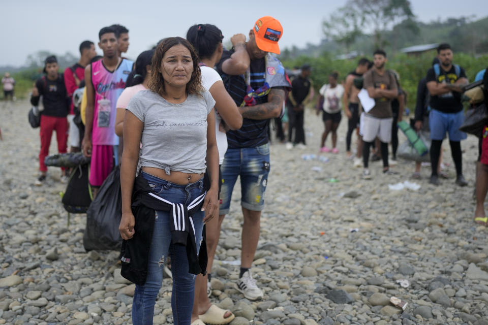 Oriana Serra lines up with other migrantes to take a boat to Lajas Blancas after walking across the Darien Gap from Colombia to Panama in hopes of reaching the U.S. in Bajo Chiquito, Panama Sunday, May 7, 2023. Back in Panama, as 34-year-old Oriana Serra neared the end of her Darien crossing with her two teen children, several men with pistols blocked their path, stealing the last of their money. (AP Photo/Natacha Pisarenko)