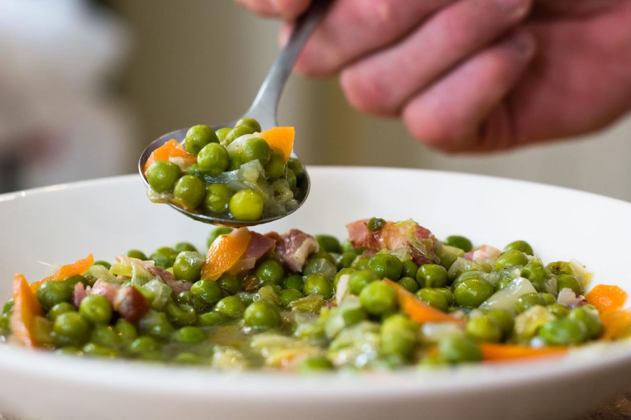 A traditional popular French dish prepared with garden peas, carrots, bacon, leek, onion and braised lettuce