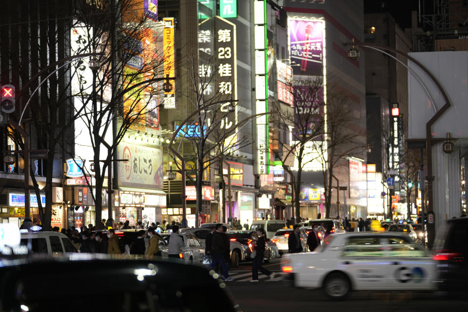 People hang out in the Susukino district of Sapporo, northern Japan, Friday, April 14, 2023. G-7 energy and environment ministers are meeting in the city on the northern Japanese island of Hokkaido ahead of a summit next month. (AP Photo/Hiro Komae)