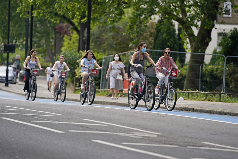 People ride bicycles in a cycle lane in Chelsea, London, after the government unveiled a further ??250 million for extra cycle lanes as the UK prepares for the lifting of the coronavirus lockdown in England.