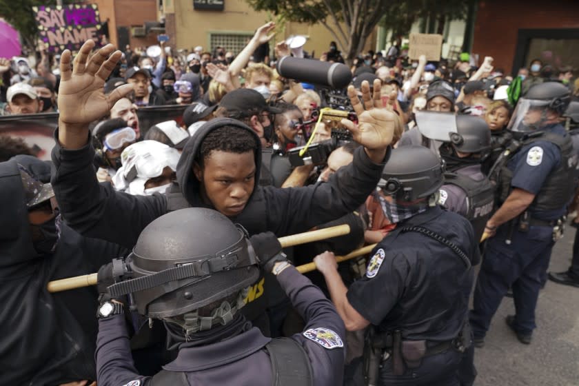 Police and protesters converge during a demonstration, Wednesday, Sept. 23, 2020, in Louisville, Ky. A grand jury has indicted one officer on criminal charges six months after Breonna Taylor was fatally shot by police in Kentucky. The jury presented its decision against fired officer Brett Hankison Wednesday to a judge in Louisville, where the shooting took place. (AP Photo/John Minchillo)