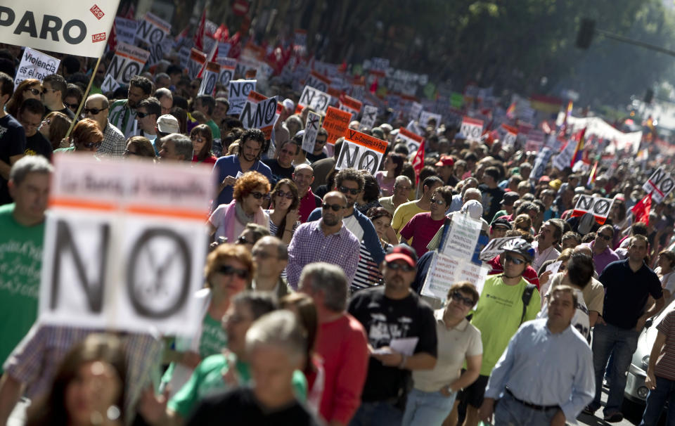 People hold banners against cuts during a demonstration in Madrid, Spain, Sunday, Oct. 7, 2012. Thousands of people called by 150 organizations are marching in 56 Spanish cities to protest punishing austerity cuts they say will only increase unemployment and job insecurity. (AP Photo/Alberto Di Lolli)