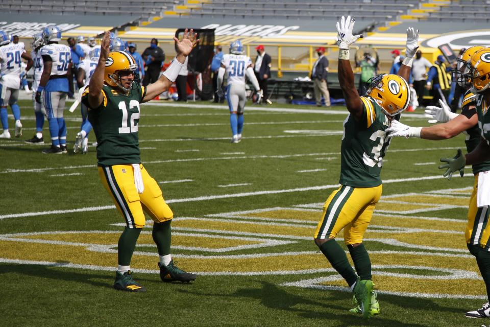 Green Bay Packers' Aaron Jones celebrates his touchdown run with Aaron Rodgers (12) during the second half of an NFL football game against the Detroit Lions Sunday, Sept. 20, 2020, in Green Bay, Wis. (AP Photo/Matt Ludtke)