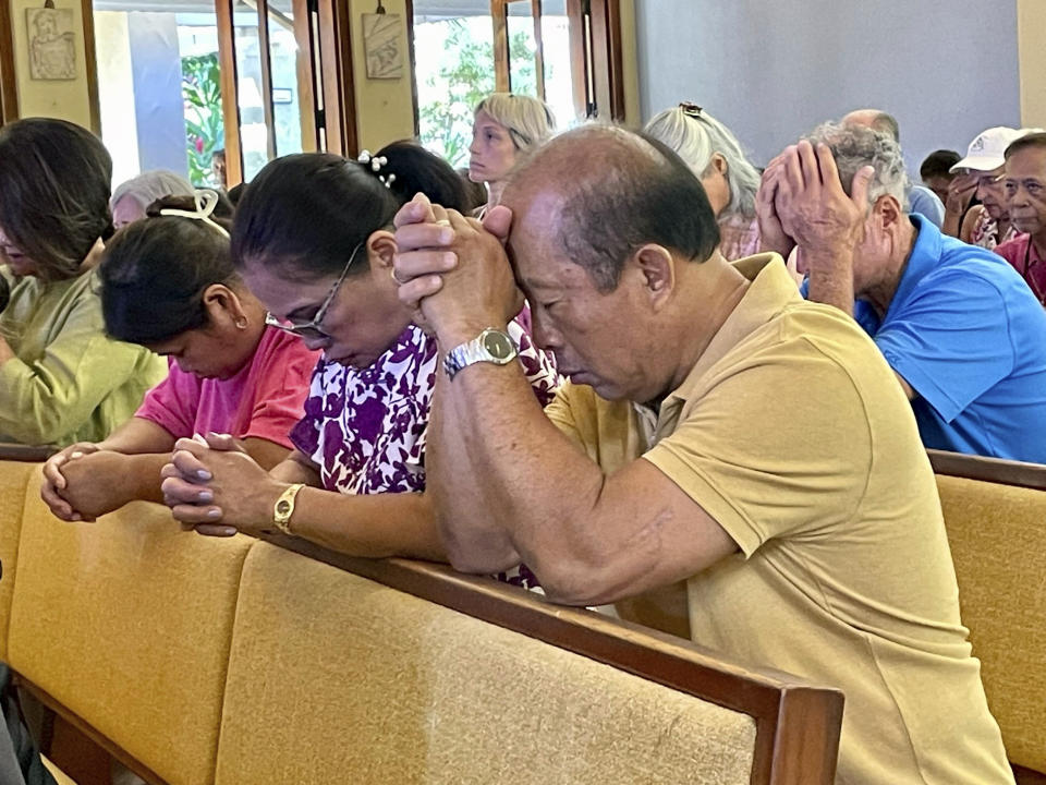 Parishioners attend Mass at Sacred Hearts Mission Church in Kapalua, Hawaii, Sunday, Aug. 13, 2023. Sacred Hearts Mission Church hosted congregants from Maria Lanakila Catholic Church in Lahaina, including several people who lost family members in fires that burned most of the Maui town days earlier. (AP Photo/Haven Daley)