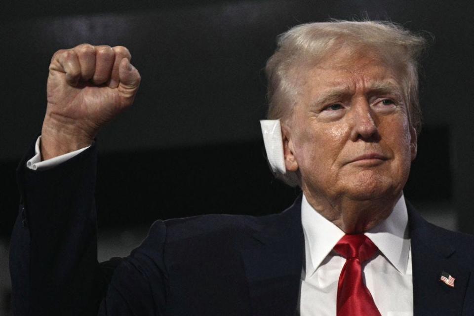 Donald Trump raises a fist with a bandage on his ear at the RNC.