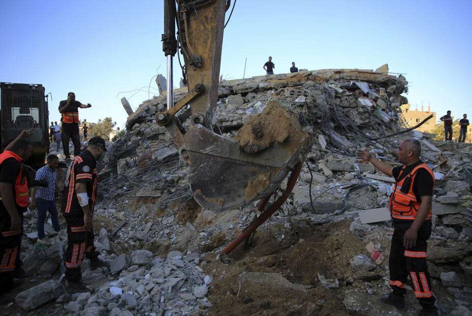 Palestinians rescuers search in the rubble for missing members of the Al-Tanani family, after their house was destroyed by Israeli airstrikes in town of Beit Lahiya, northern Gaza Strip, Thursday, May 13, 2021. (AP Photo/Abdel Kareem Hana)