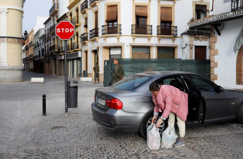 Spanish legionnaires patrol an empty street in downtown Ronda