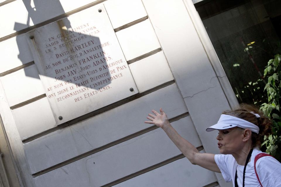 In this photo taken Friday, July 19, 2013, tour guide Shari Segall shows the marble plaque on the building used to be the Hotel d'York where "The Treaty of Paris" was signed by Thomas Jefferson in 1783 during a Guided Tour around the main spots of the Revolutonary-era American presence on Paris' left bank, in Paris, France. (AP Photo/Francois Mori)