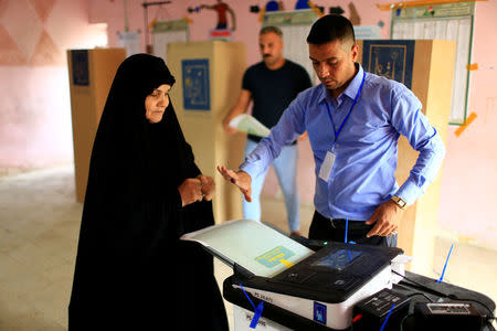 An Iraqi woman casts her vote at a polling station during the parliamentary election in Baghdad, Iraq May 12, 2018. REUTERS/Thaier al-Sudani