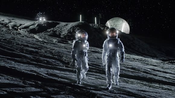 Astronauts walking on the moon near moon base.