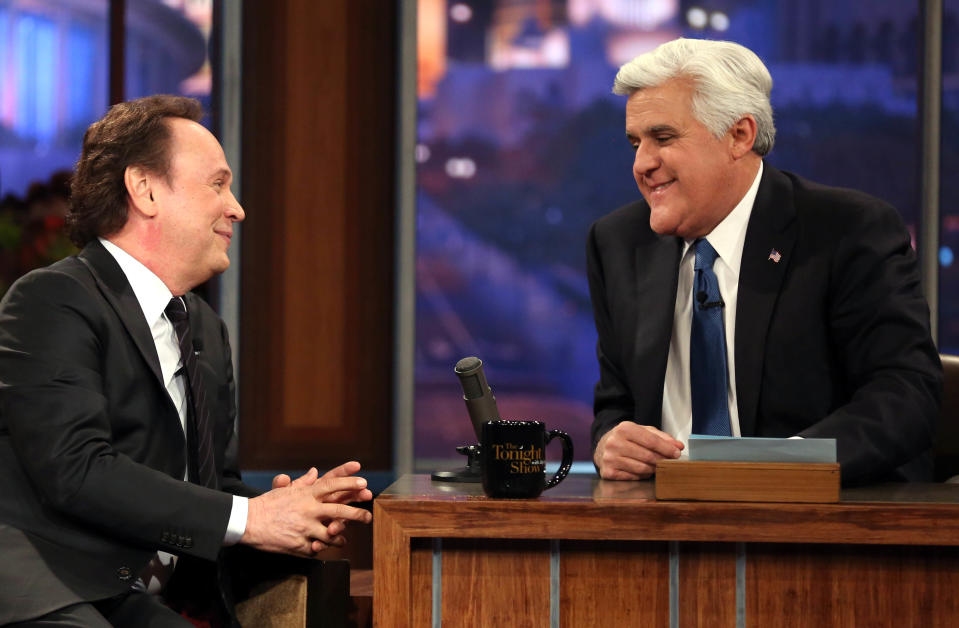 Billy Crystal, left, talks to host Jay Leno during the final taping of NBC's “The Tonight Show with Jay Leno," in Burbank, Calif., Thursday, Feb. 6, 2014. Leno brings his 22-year career as the show host to an end Thursday in a special one-hour farewell broadcast. (Photo by Matt Sayles/Invision/AP)