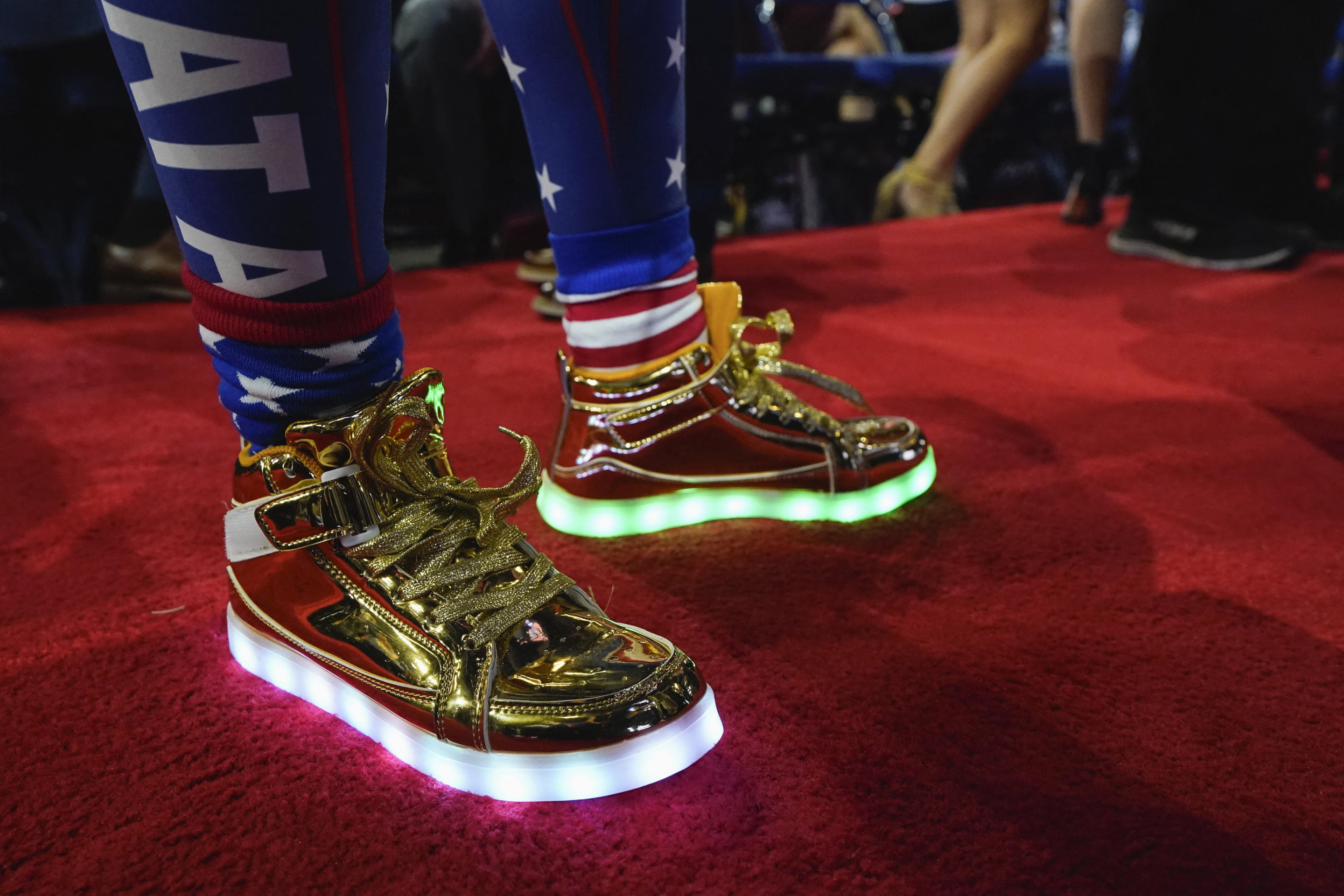 An attendee wears an illuminated pair of shoes. 