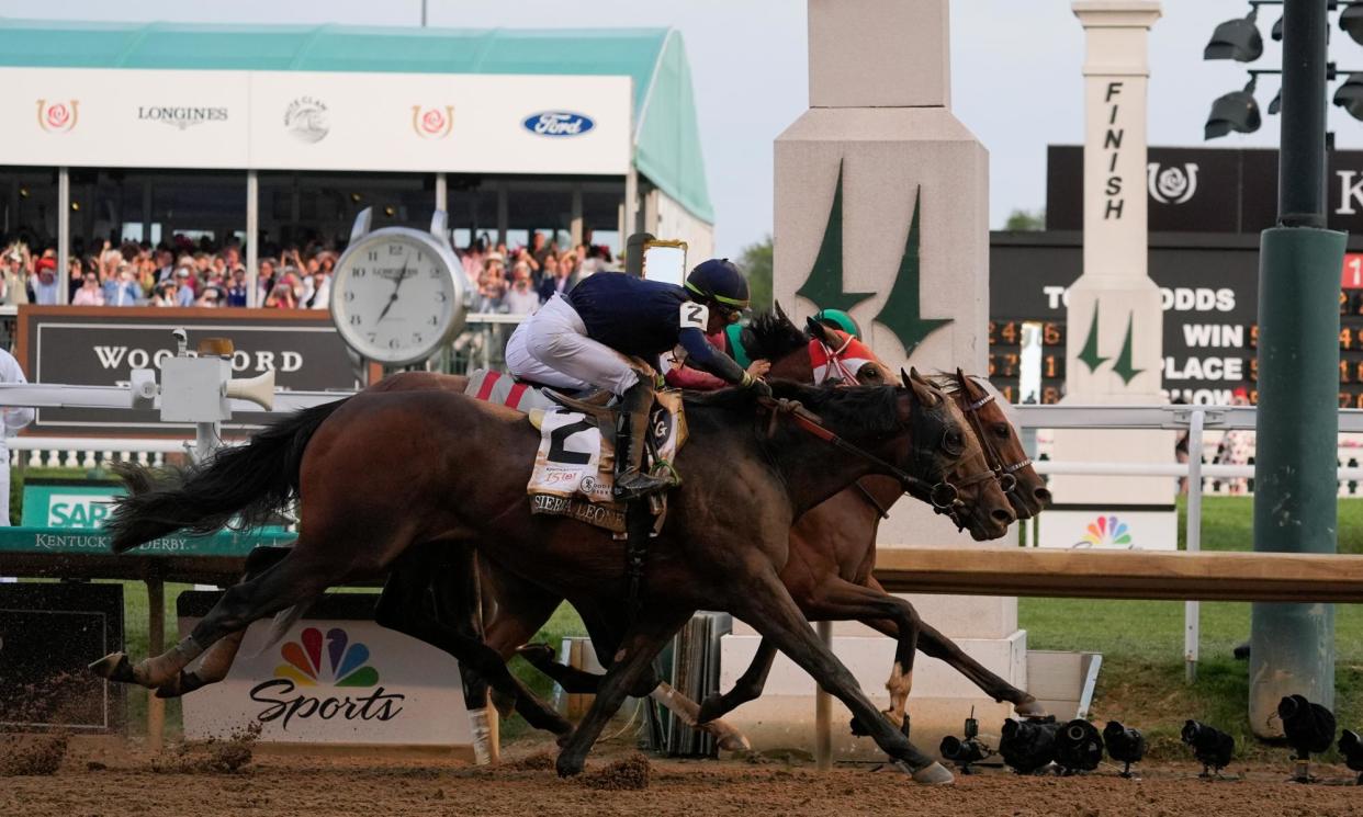 <span>Mystik Dan, rear, with jockey Brian Hernandez Jr, crosses the finish line at Churchill Downs first ahead of Sierra Leone and Forever Young in the 150th running of the Kentucky Derby on Saturday.</span><span>Photograph: Kiichiro Sato/AP</span>