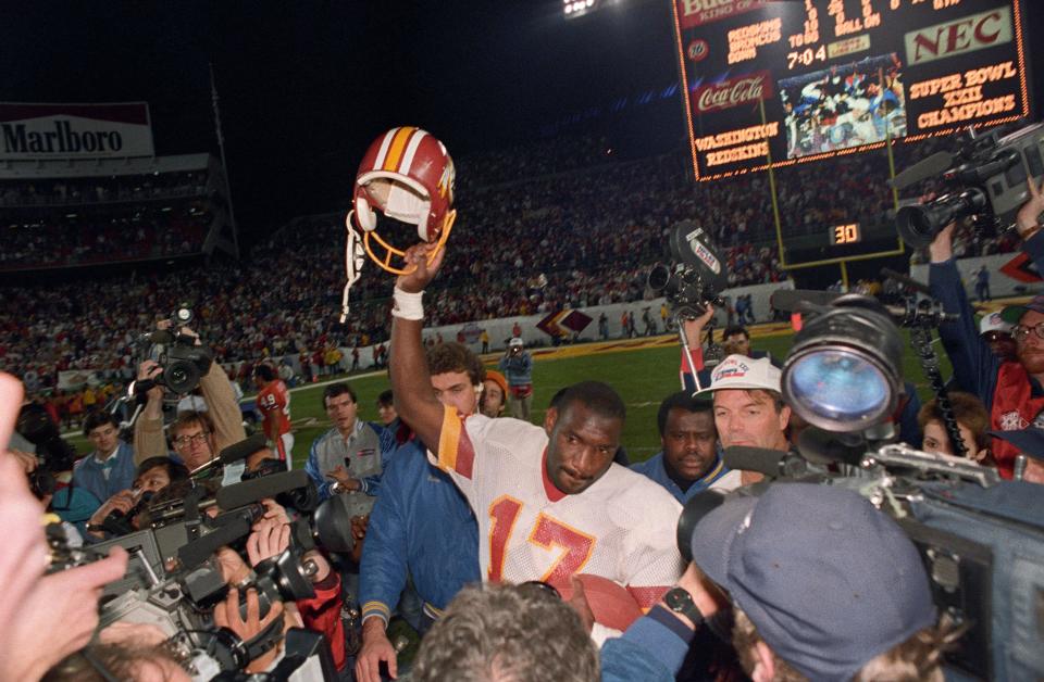 Jan 31, 1988; San Diego, CA, USA; FILE PHOTO;  Washington Redskins quarterback Doug Williams (17) celebrates on the field after defeating the Denver Broncos 42-10 to win Super Bowl XXII at Jack Murphy Stadium. Mandatory Credit: Darr Beiser-USA TODAY Sports