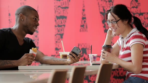 Couple at McDonald's looking at phone