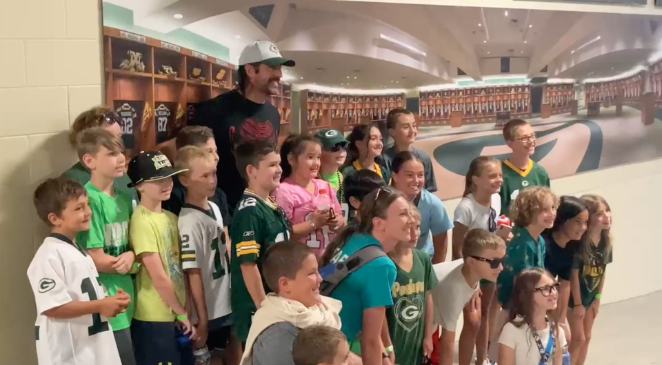 Aaron Rodgers visits with a Boys and Girls Club while on a tour of Lambeau Field.