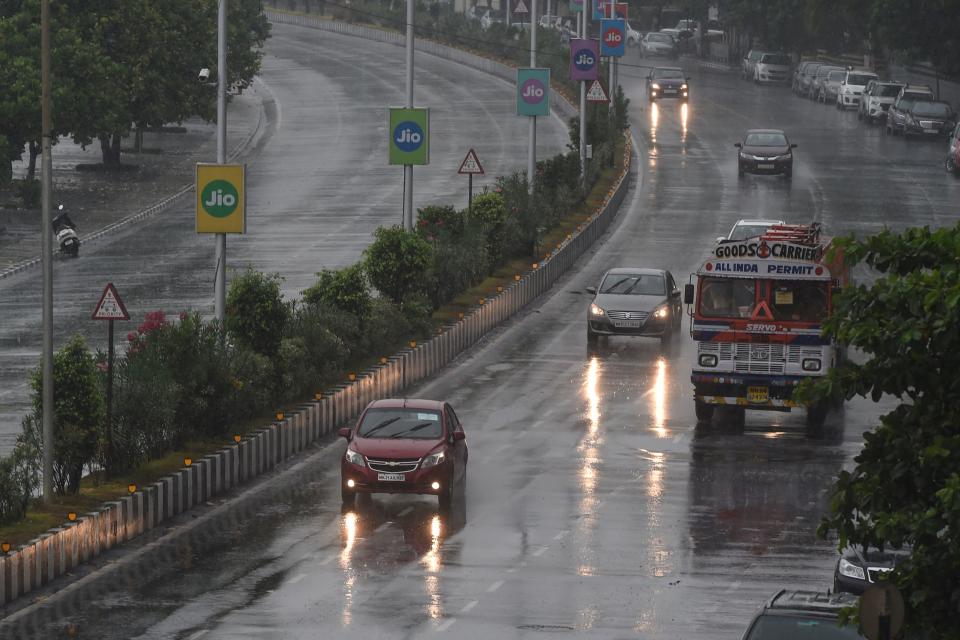 Commuters drive along Marine Drive as rain falls in Mumbai on June 3, 2020. (Photo by PUNIT PARANJPE/AFP via Getty Images)