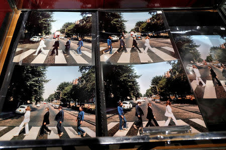 Five alternate pictures for the cover of Abbey Road are displayed by French Beatles specialist and collector Jacques Volcouve, one of the world's greatest living experts of the band, at Drouot auction house in Paris, March 16, 2017, a part of the 15,000 items going on sale on next March 18. REUTERS/Charles Platiau
