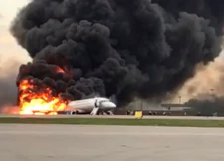 A passenger plane is seen on fire after an emergency landing at the Sheremetyevo Airport outside Moscow, Russia May 5, 2019. The Investigative Committee of Russia/Handout via REUTERS