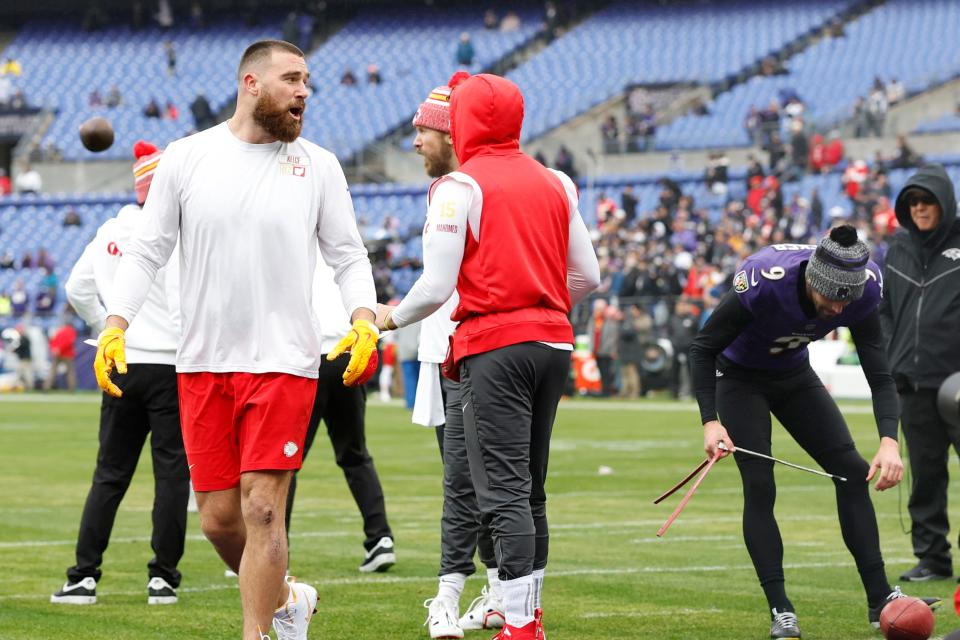 Chiefs tight end Travis Kelce exchanges words with Ravens kicker Justin Tucker for warming up on the visitors' side of the field before Sunday's AFC championship game in Baltimore.