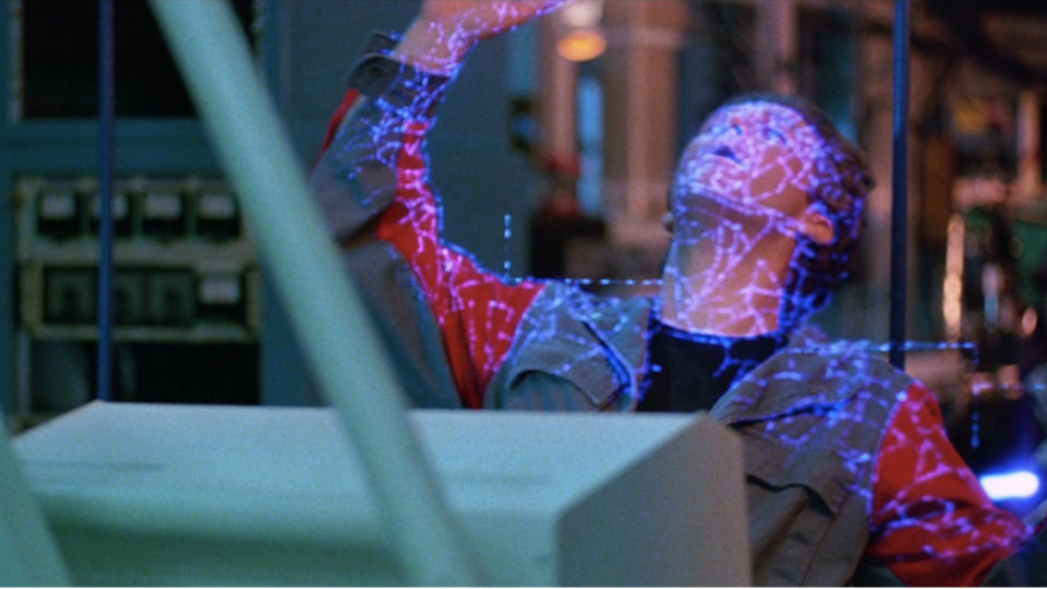 Jeff Bridges being zapped by a laser from behind in Tron.