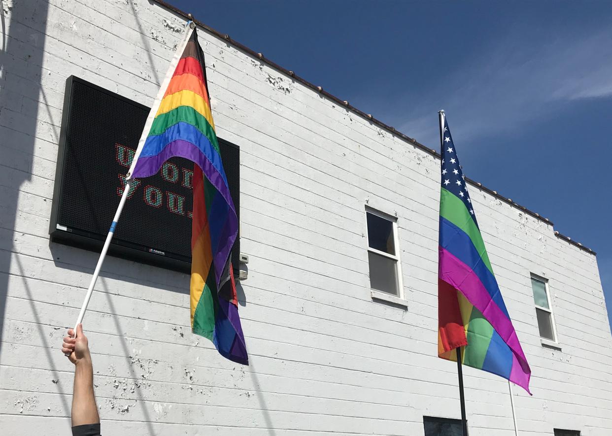 LGBTQ pride flags outside of a building on North Richmond Street in Appleton.