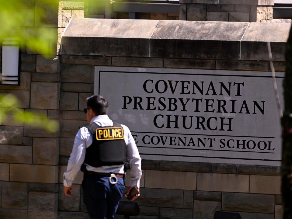 image of police officer walking in front of entrance sign to Covenant Presbyterian Church and school