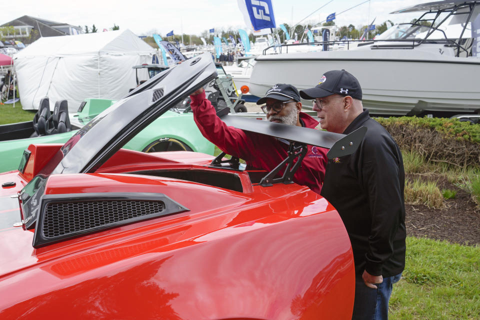 Former Maryland Gov. Larry Hogan, right, talks with Ronald Cole, of Annapolis, Md., while looking at a JetCar as Hogan visits the Bridge Boat Show in Stevensville, Md., Friday, April 12, 2024, as he campaigns for the U.S. Senate. (AP Photo/Susan Walsh)