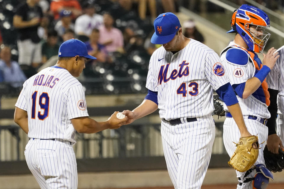 New York Mets starting pitcher Jerad Eickhoff (43) hands the ball to manager Luis Rojas (19) after being removed during the fourth inning of the team's baseball game against the Atlanta Braves, Tuesday, July 27, 2021, in New York. (AP Photo/Mary Altaffer)