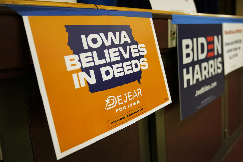 A campaign sign for Iowa Democratic gubernatorial candidate Deidre DeJear is seen on the stage at the Story County Democrats Super Soup Fundraiser, Saturday, March 12, 2022, in Nevada, Iowa. (AP Photo/Charlie Neibergall)