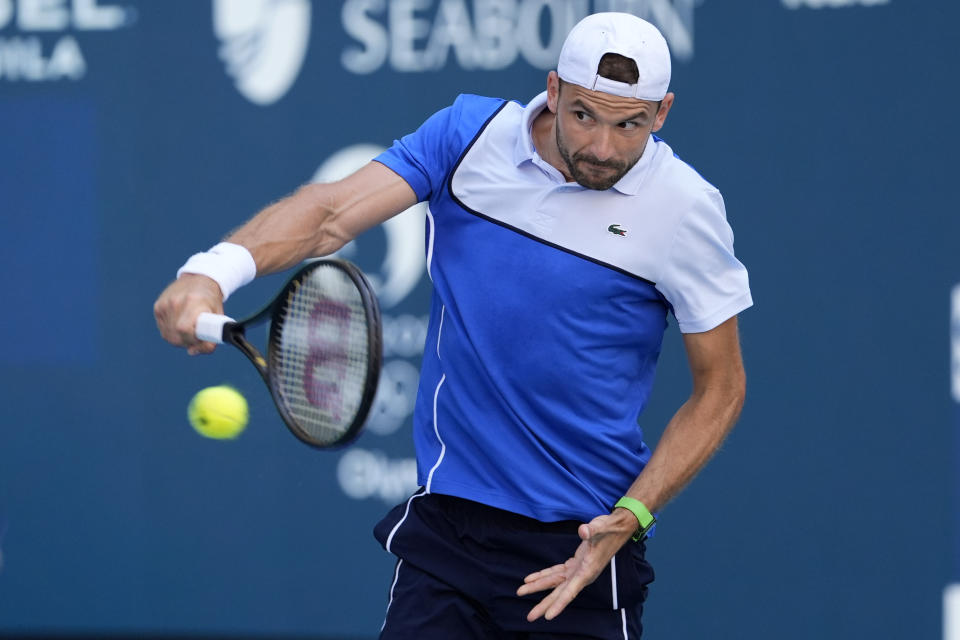 Grigor Dimitrov, of Bulgaria, hits a return to Jannik Sinner, of Italy, during the men's final at the Miami Open tennis tournament, Sunday, March 31, 2024, in Miami Gardens, Fla. (AP Photo/Lynne Sladky)