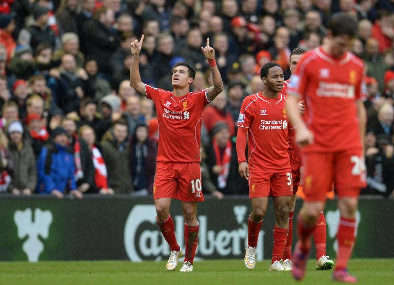 Philippe Coutinho (L) celebrates scoring Liverpool's second and winning goal against Manchester City on March 1, 2015