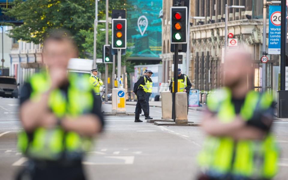 Police cordon off the area around at the scene in London Bridge and Borough Market in London - Credit: PA