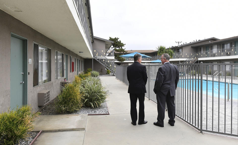 FILE - In this June 20, 2019, file photo, Los Angeles County Deputy District Attorney Dan Akemon, left, and detective Tom Small look at the view from rooms involved in the murder trial of Michael Gargiulo at an apartment complex as jurors visit the scene in El Monte, Calif. In 2001, Gargiulo allegedly stabbed to death 22-year-old Ashley Ellerin, an acquaintance of actor Ashton Kutcher. Kutcher testified that he went to pick up the model for a drink but that she did not answer the door. Her body was found the next day in her Hollywood Hills home. (Frederic J. Brown/Pool Photo via AP, File)