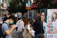 Supporters write on postcards to twelve Hong Kong detained activists, apprehended as they reportedly sailed to Taiwan for political asylum, at a booth in Hong Kong